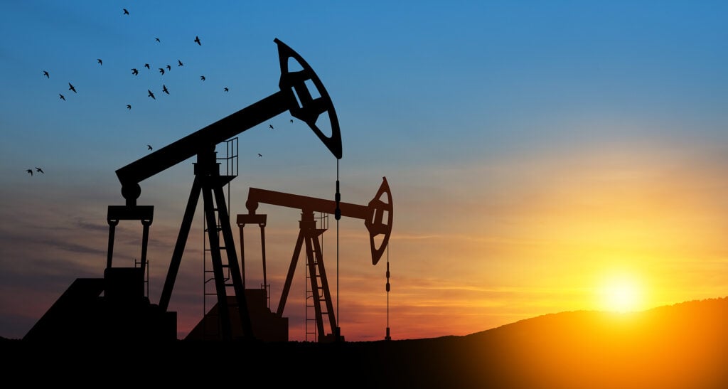 Oil drilling derricks at desert oilfield. 